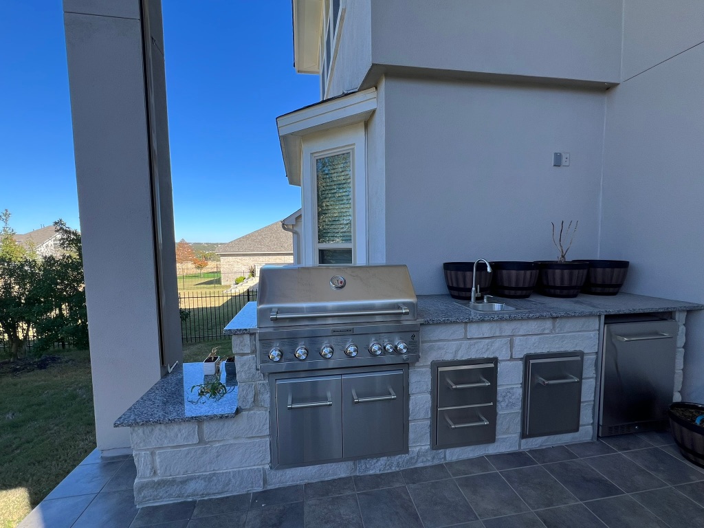4121 Cappello Way Leander, TX 78641 - Photo 10 of 40 a kitchen with stainless steel appliances granite countertop a stove and a microwave