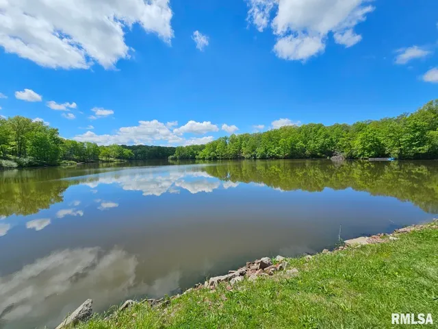 a view of a lake with houses in the back