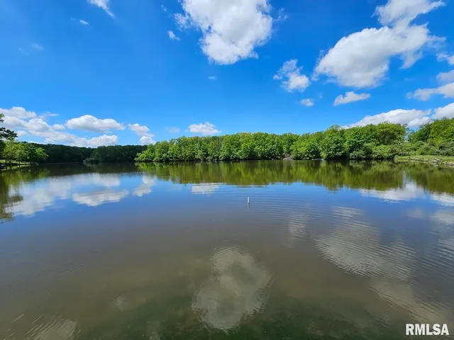 a view of a lake in middle of a house with a lake view