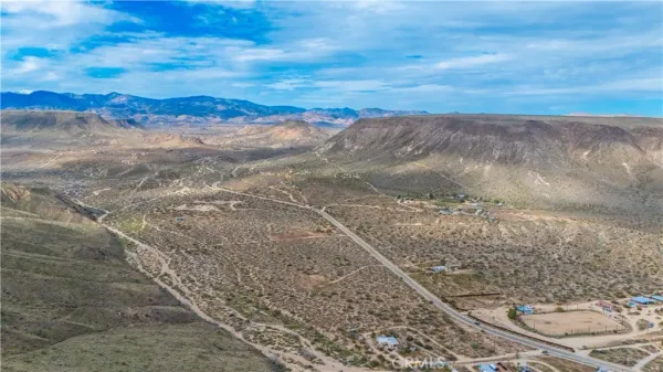 a view of a yard with a mountain