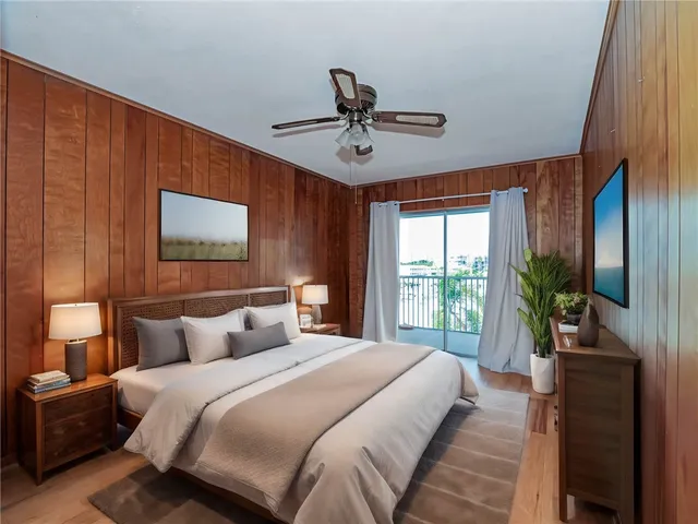 a bedroom with a large bed and a chandelier