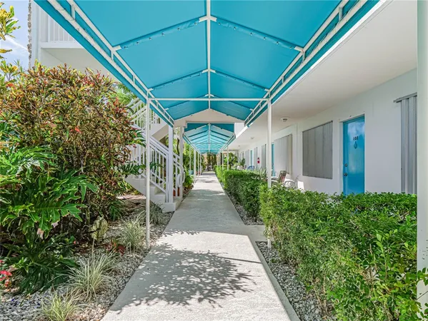 a view of a patio with a table and chairs under an umbrella