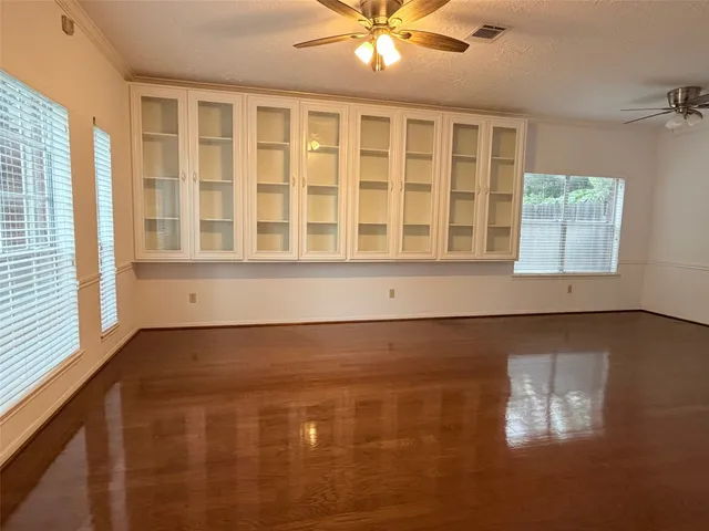 a view of a livingroom with furniture and chandelier fan