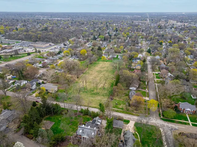 an aerial view of residential houses with outdoor space and swimming pool