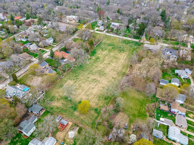 a backyard of a house with a lots of trees and flowers