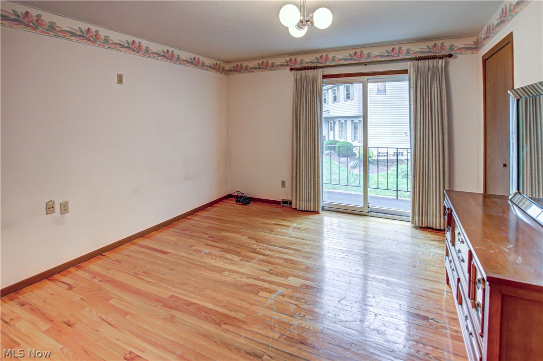 6013 Rousseau Drive Parma, OH 44129 - Photo 25 of 50 Unfurnished bedroom featuring a notable chandelier and light wood-type flooring