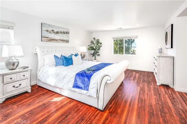 a spacious bedroom with a bed and a window