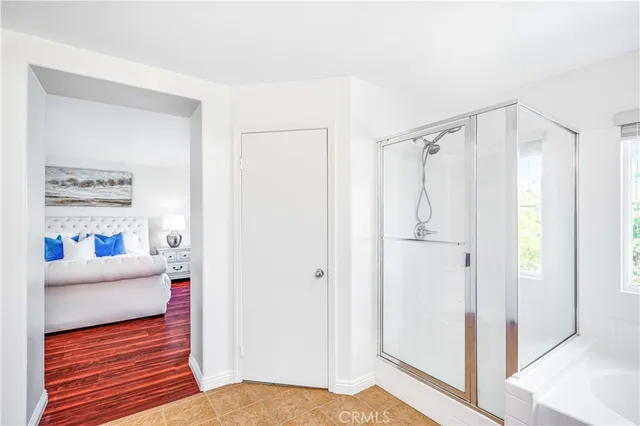 a view of a bedroom with furniture and window