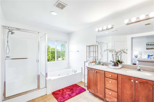 a bathroom with a tub sink and mirror
