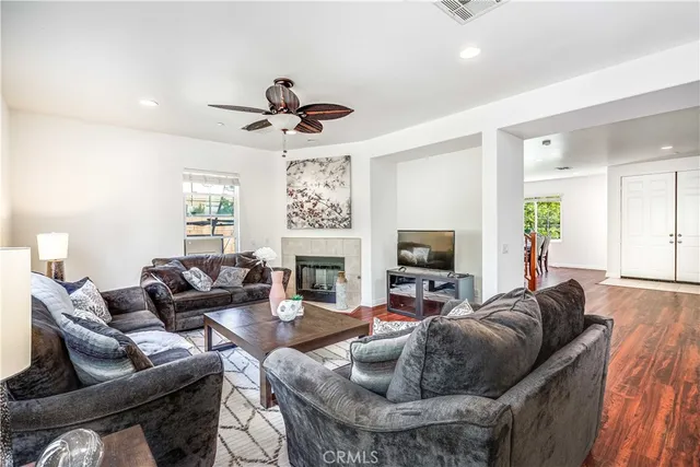 a living room with furniture a fireplace and a flat screen tv