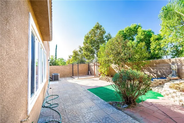 a view of a house with a yard and potted plants