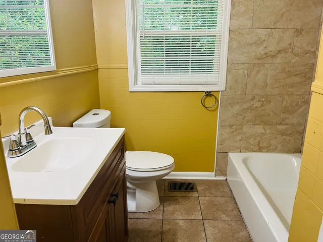 a bathroom with a sink a toilet and tub