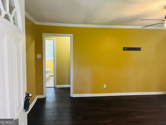 a view of a room with wooden floor and a window