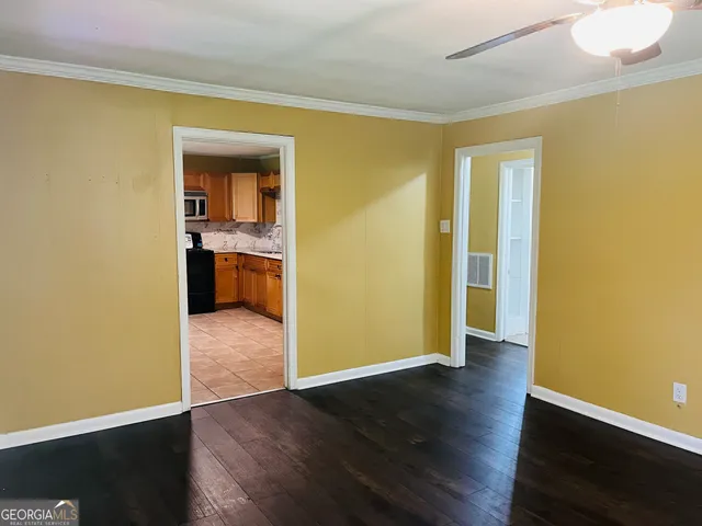 an empty room with wooden floor and a window