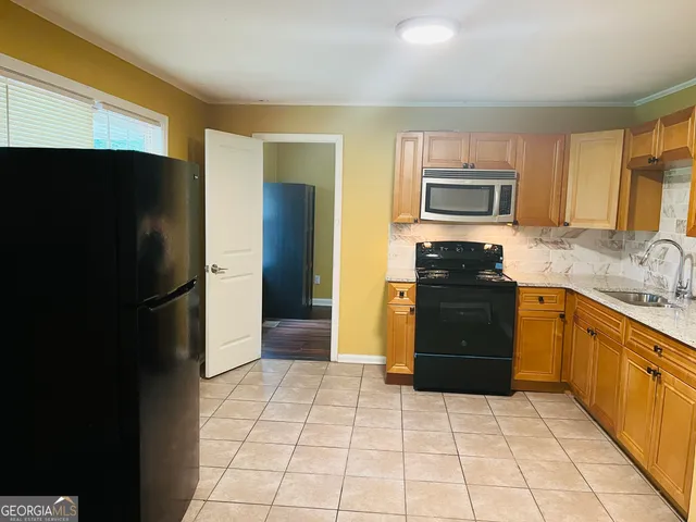 a kitchen with a refrigerator sink and microwave