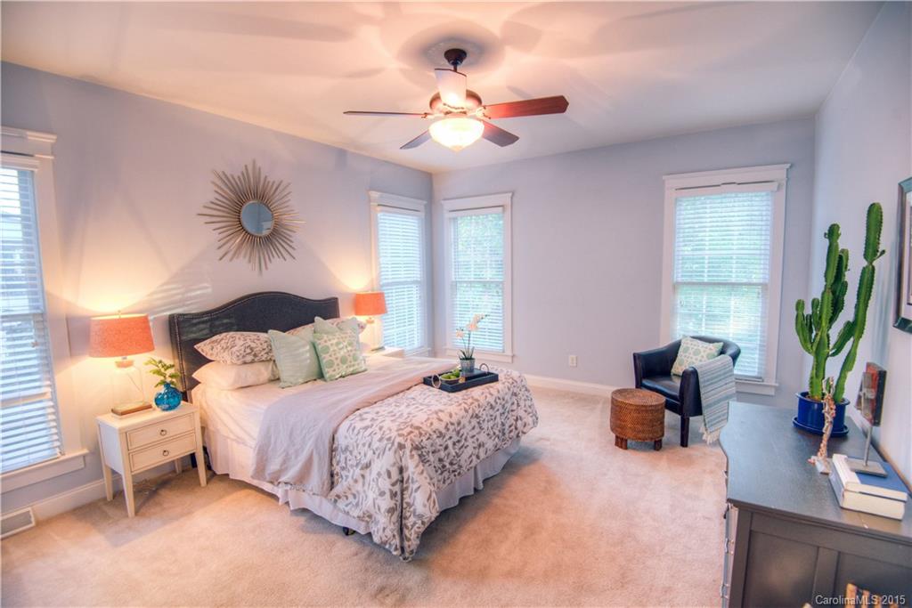 915 Derricks Crossing Fort Mill, SC 29708 - Photo 13 of 24 a bedroom with a bed and a chandelier