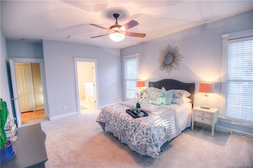 915 Derricks Crossing Fort Mill, SC 29708 - Photo 14 of 24 a bedroom with a bed and a chandelier