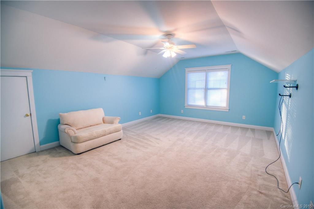 915 Derricks Crossing Fort Mill, SC 29708 - Photo 18 of 24 a living room with furniture and a chandelier