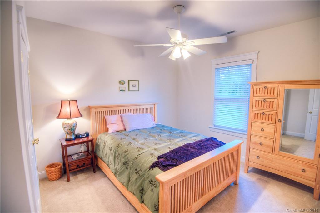 915 Derricks Crossing Fort Mill, SC 29708 - Photo 19 of 24 a bedroom with a bed and a chandelier