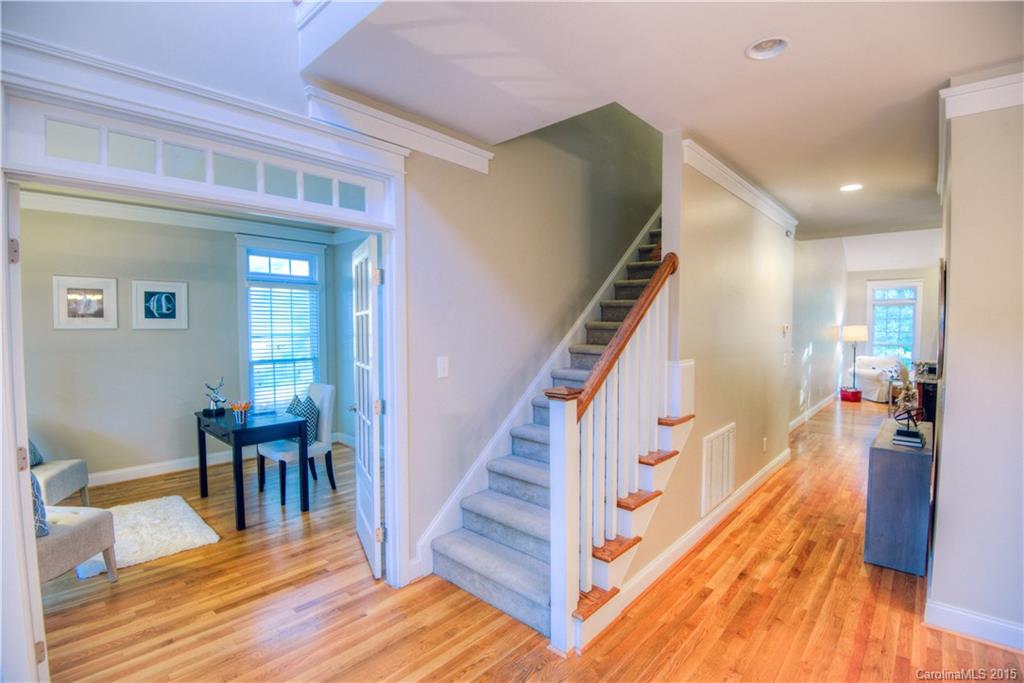 915 Derricks Crossing Fort Mill, SC 29708 - Photo 4 of 24 a view of a hallway with wooden floor and stairs