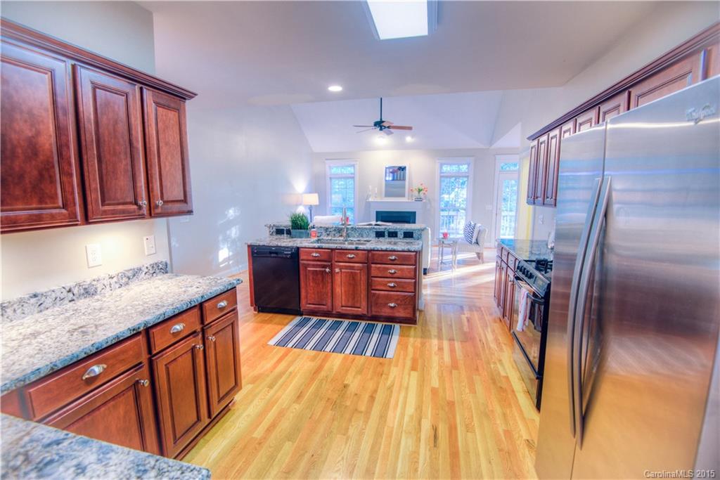 915 Derricks Crossing Fort Mill, SC 29708 - Photo 8 of 24 a kitchen with wooden floors and wooden cabinets