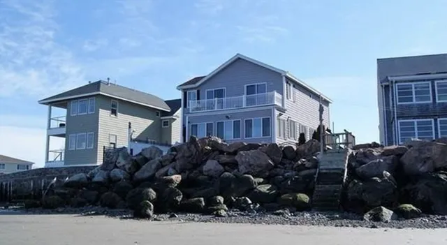 a view of a livingroom with wooden floor and furniture