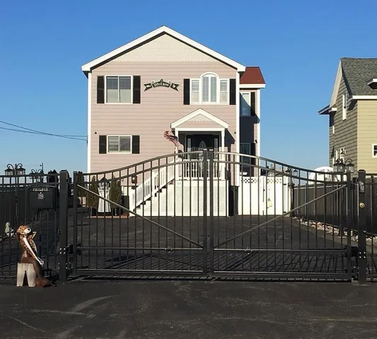 a view of a house with iron fence