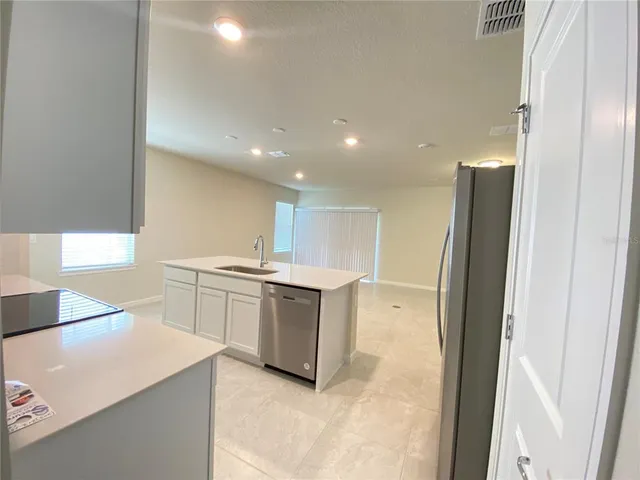 a kitchen with a refrigerator and a sink