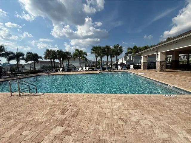 a view of a white house with a yard and plants