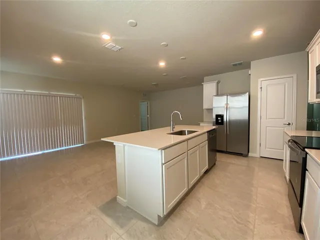a kitchen with stainless steel appliances granite countertop a white stove top oven and refrigerator