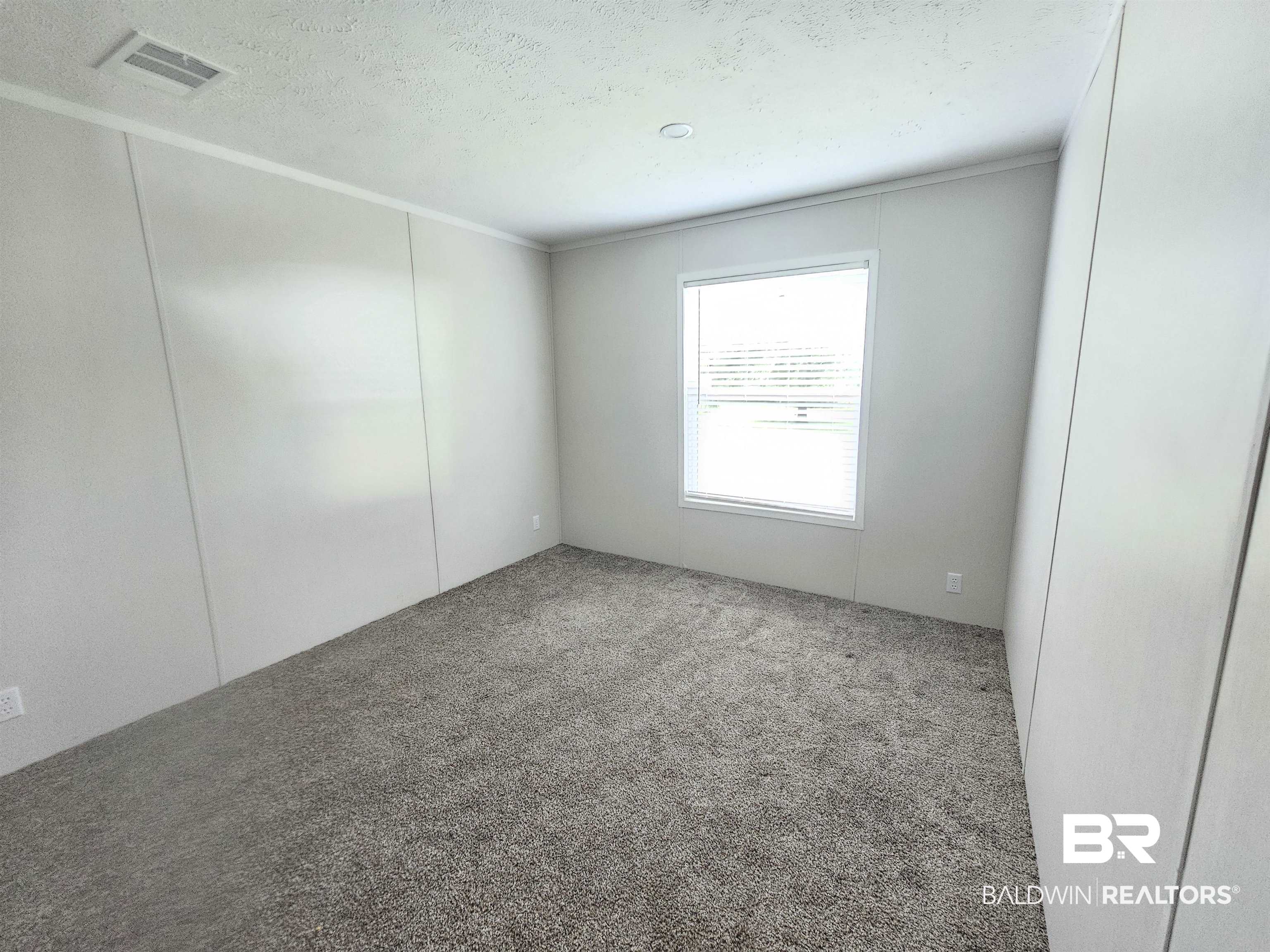 1863 Wait Road Monroeville, AL 36460 - Photo 14 of 38 Unfurnished room featuring a textured ceiling and carpet flooring
