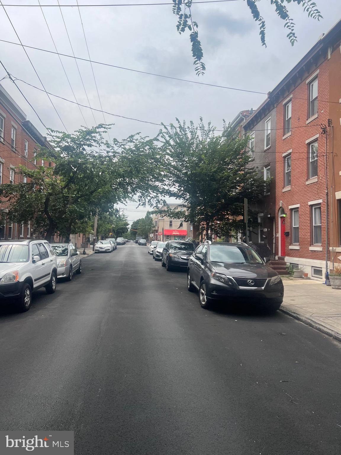 a view of street with parked cars