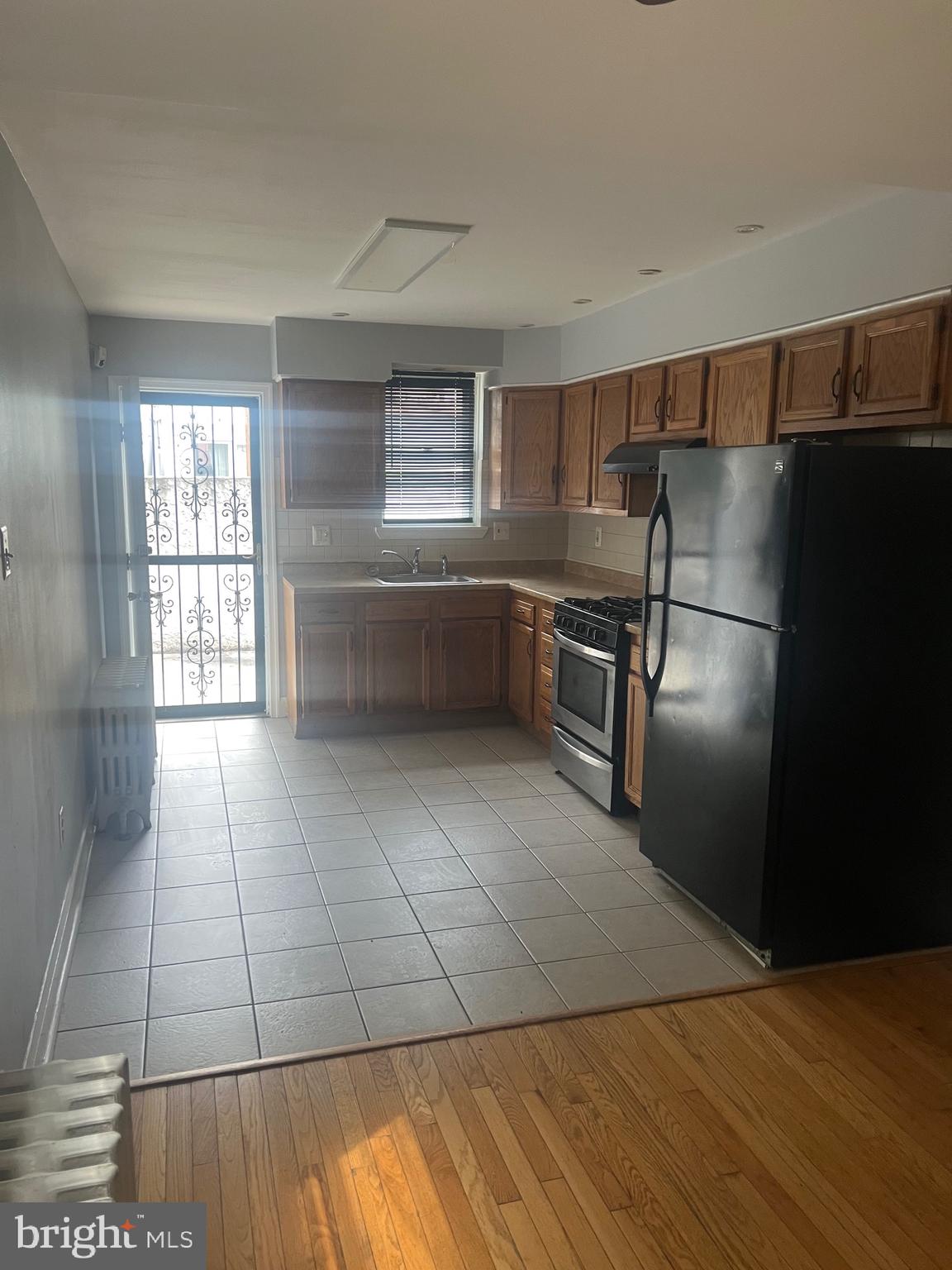 1917 Carpenter Street Philadelphia, PA 19146 - Photo 3 of 28 a kitchen with granite countertop a refrigerator and a stove top oven