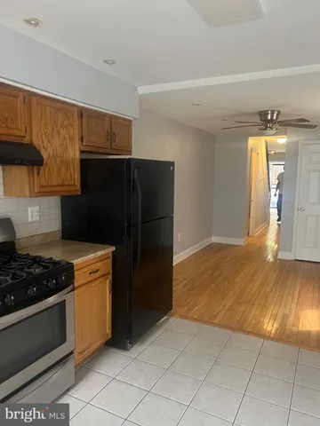 a kitchen with granite countertop a stove and a refrigerator