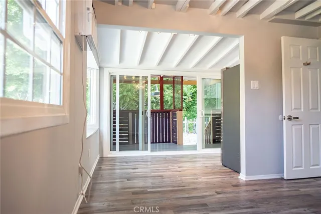 a view of a room with wooden floor and windows