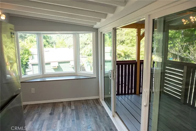 a view of a room with wooden floor and a window