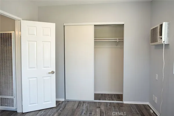 a view of walk in closet with wooden floor