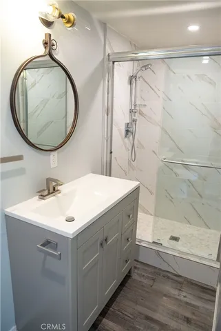 a bathroom with a sink a mirror and a shower