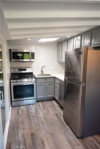 a kitchen with cabinets and stainless steel appliances