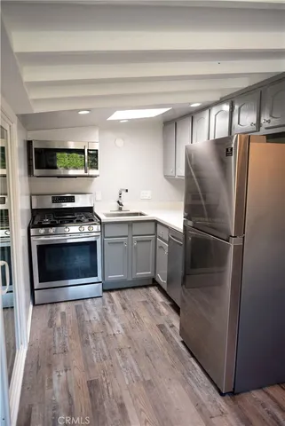a kitchen with cabinets and stainless steel appliances