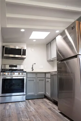 a kitchen with stainless steel appliances granite countertop a stove and a refrigerator