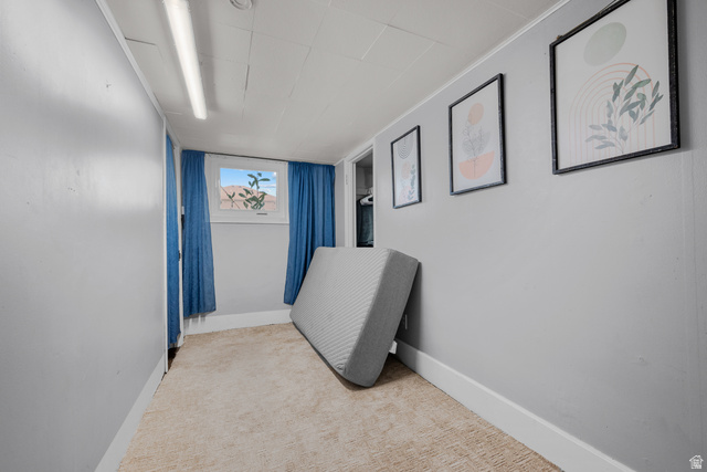 1275 North Geneva Road Provo, UT 84601 - Photo 18 of 25 Light gray interior walls with white trim, beige carpeting, and a single window with blue drapes