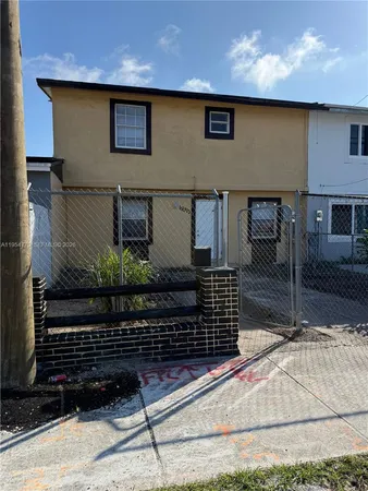 a brick building with a bench in front of it