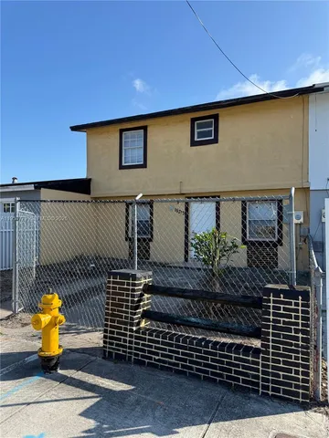 a view of a brick house with wooden floor