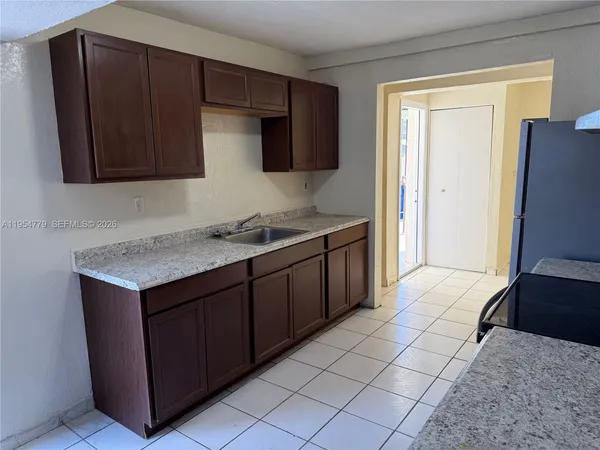a kitchen with a stove and a refrigerator