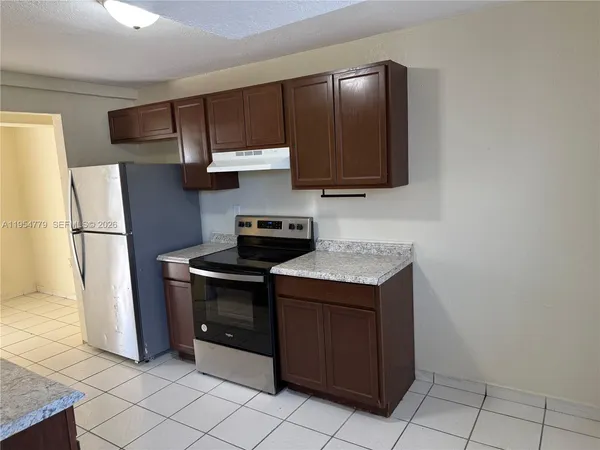 a kitchen with stainless steel appliances granite countertop a stove a refrigerator and a refrigerator