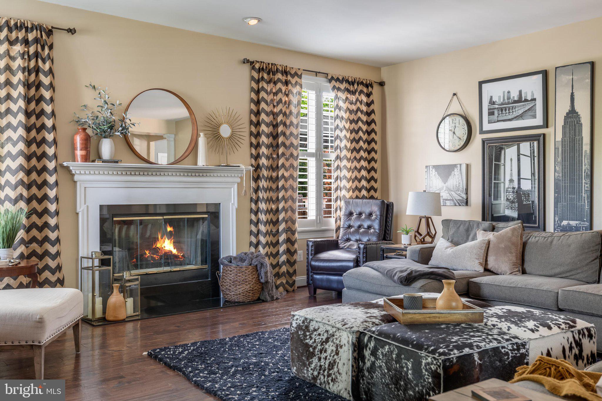 25554 Mimosa Tree Court Chantilly, VA 20152 - Photo 23 of 85 a living room with furniture a large window and a fireplace