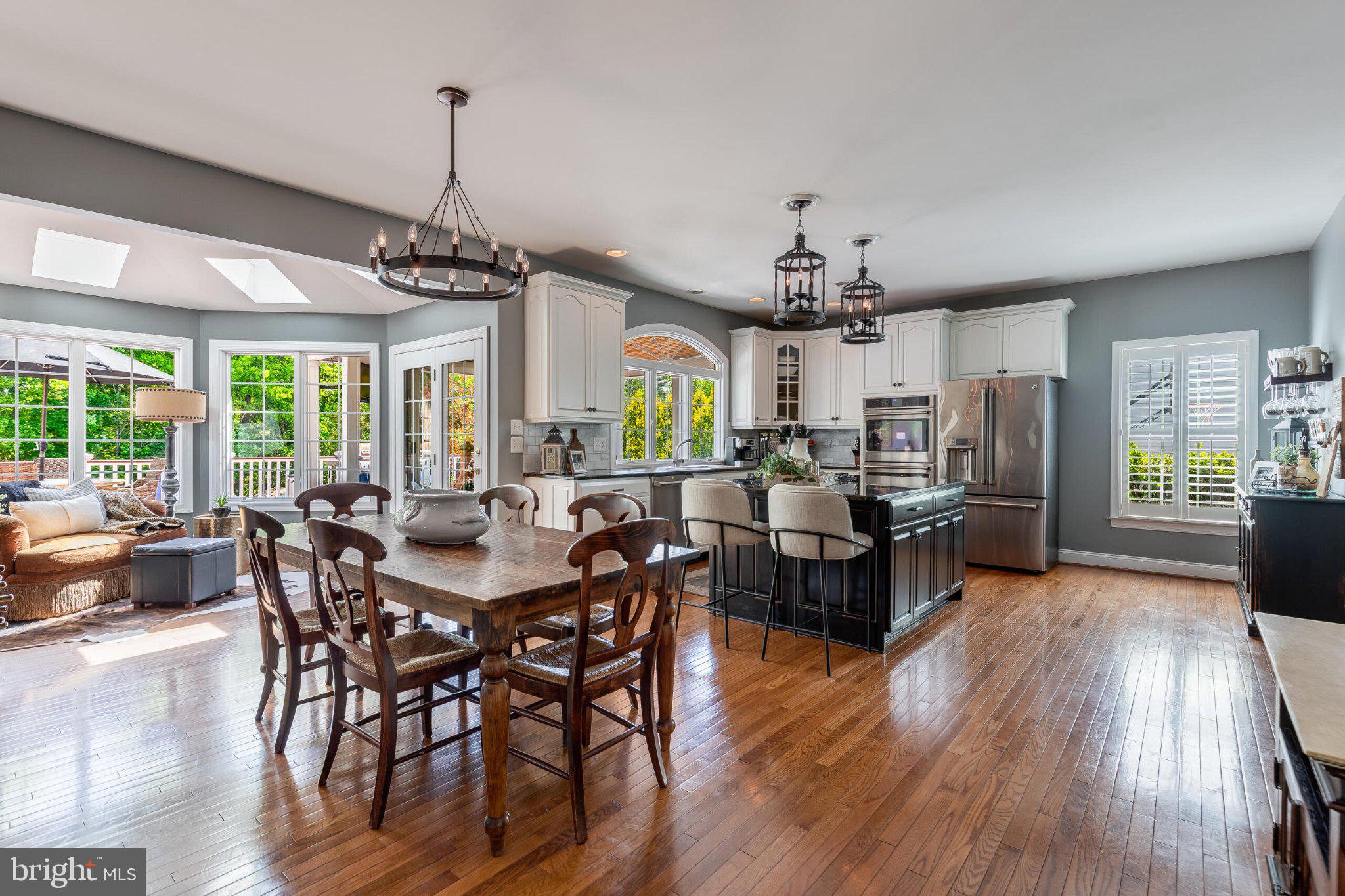 25554 Mimosa Tree Court Chantilly, VA 20152 - Photo 24 of 85 a view of a dining room and livingroom with furniture wooden floor a chandelier