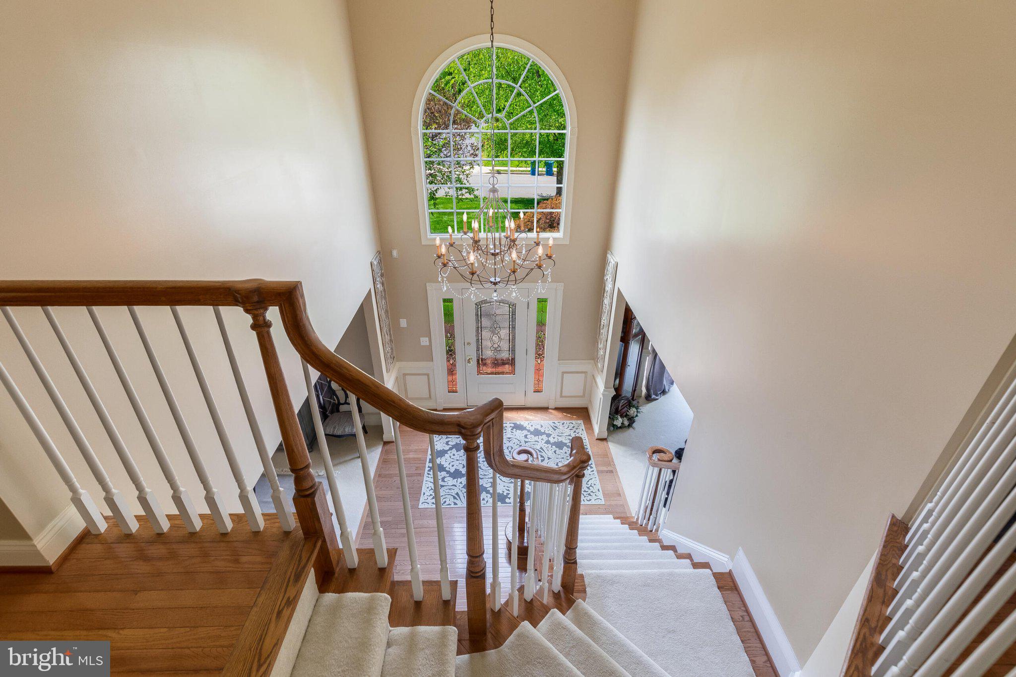 25554 Mimosa Tree Court Chantilly, VA 20152 - Photo 47 of 85 Elegant staircase with grand chandelier.