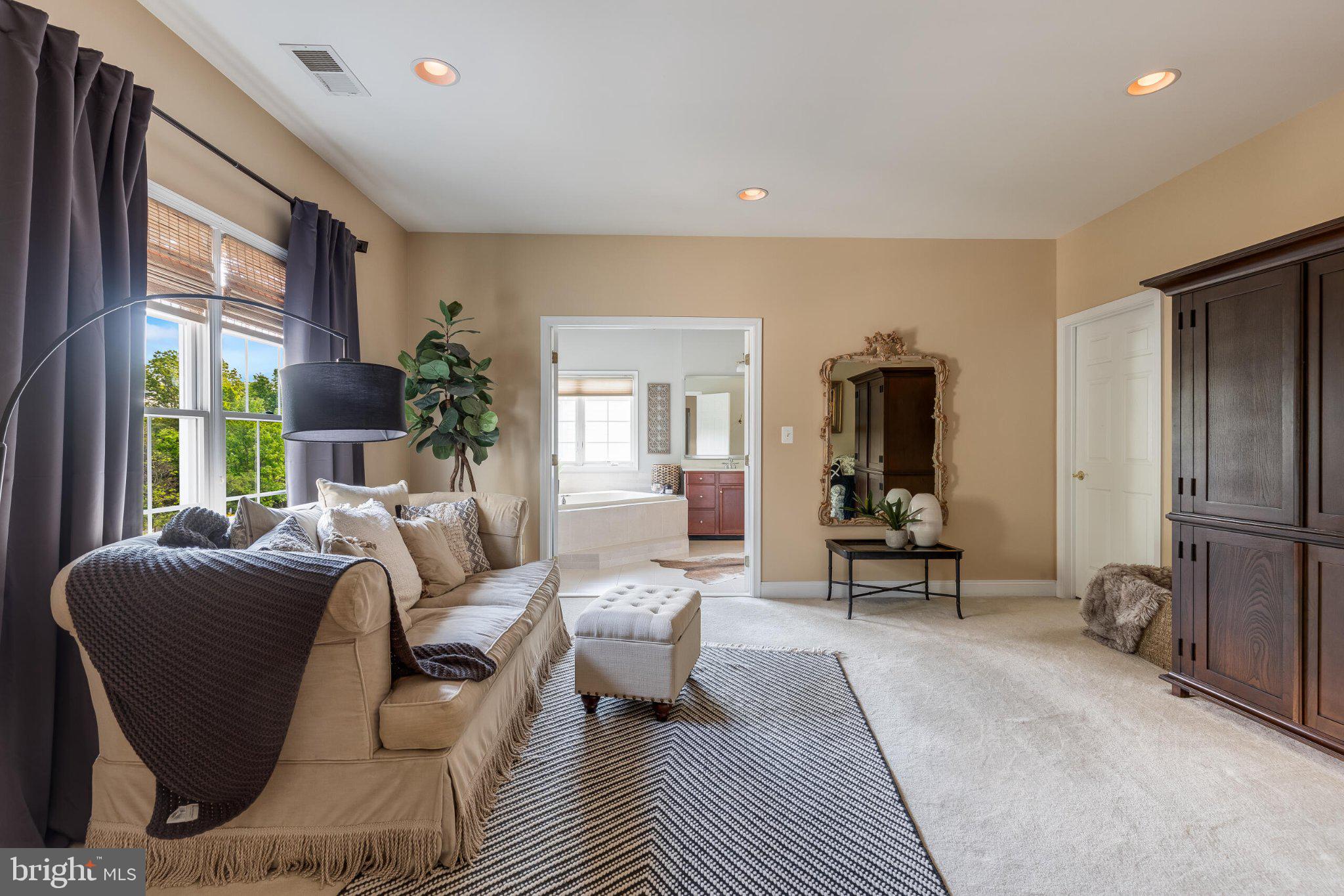 25554 Mimosa Tree Court Chantilly, VA 20152 - Photo 52 of 85 a living room with furniture a large window and gym equipment
